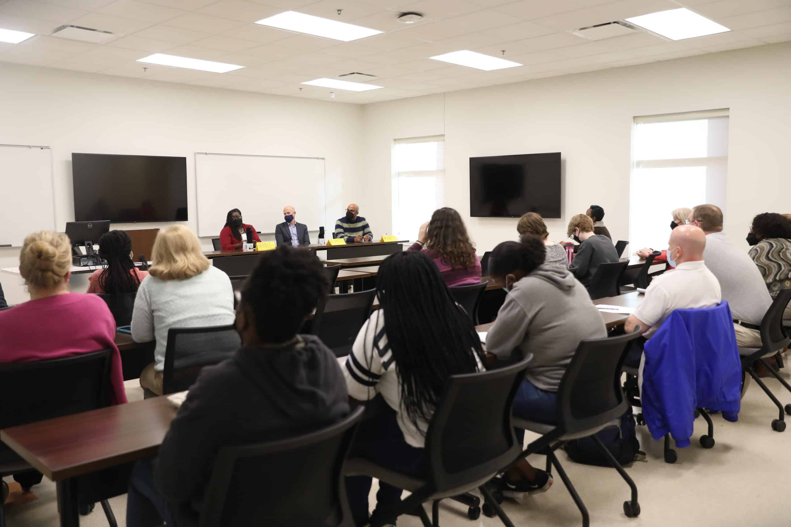 Students and faculty listen during a panel discussion.
