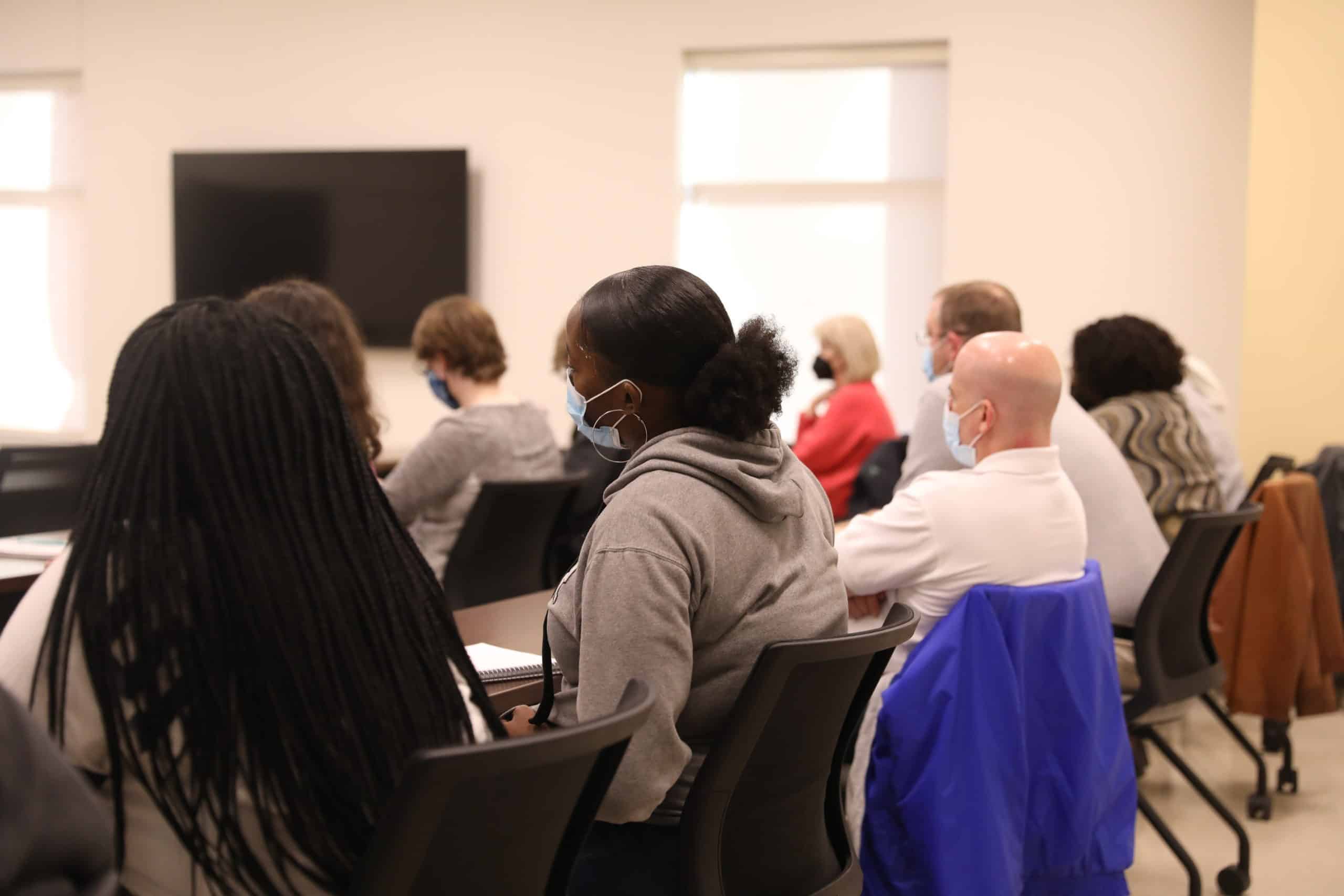 Students and faculty listen during a panel discussion.