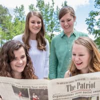 Editors of the Patriot reading the newspaper