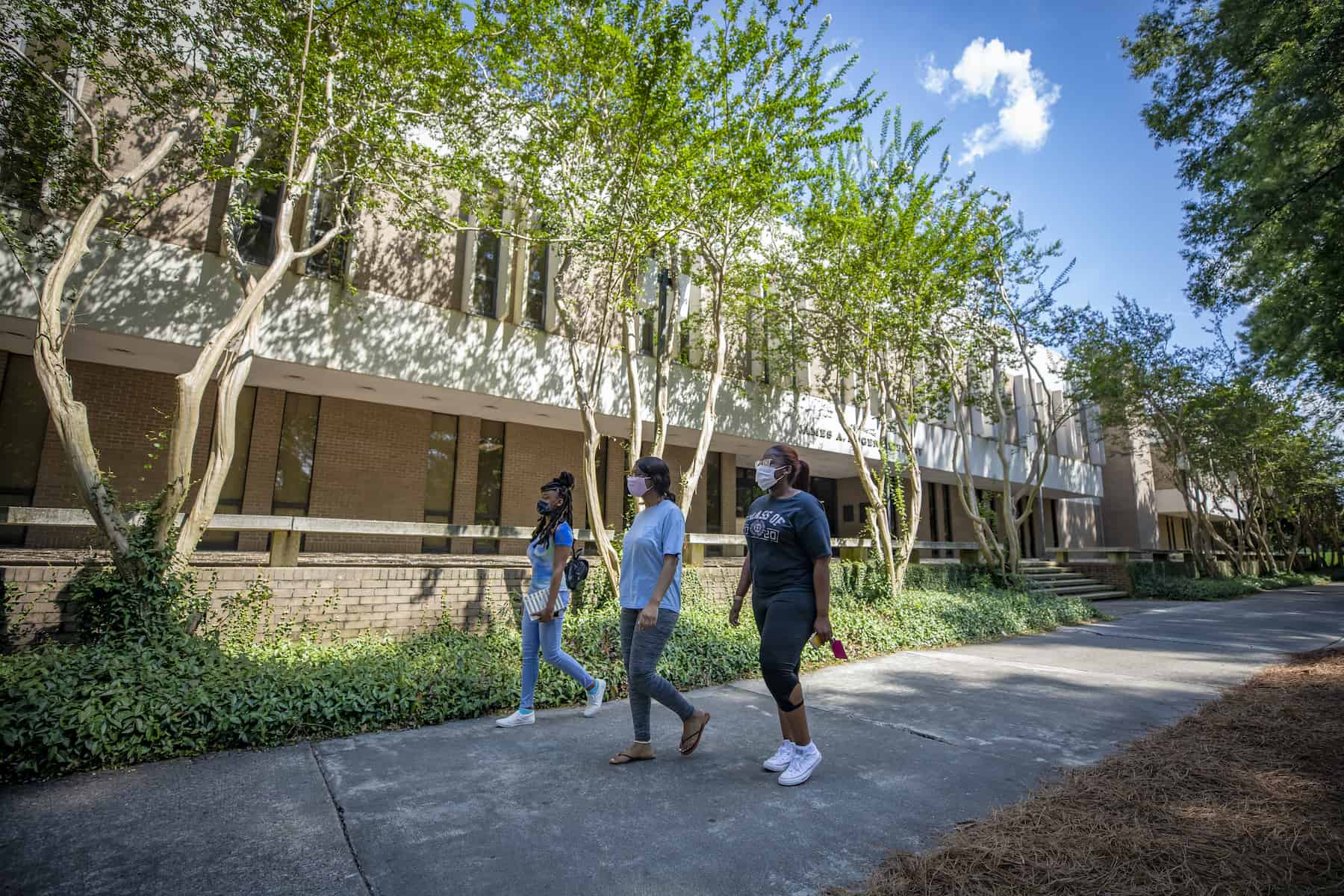 Students walking in front of the Library