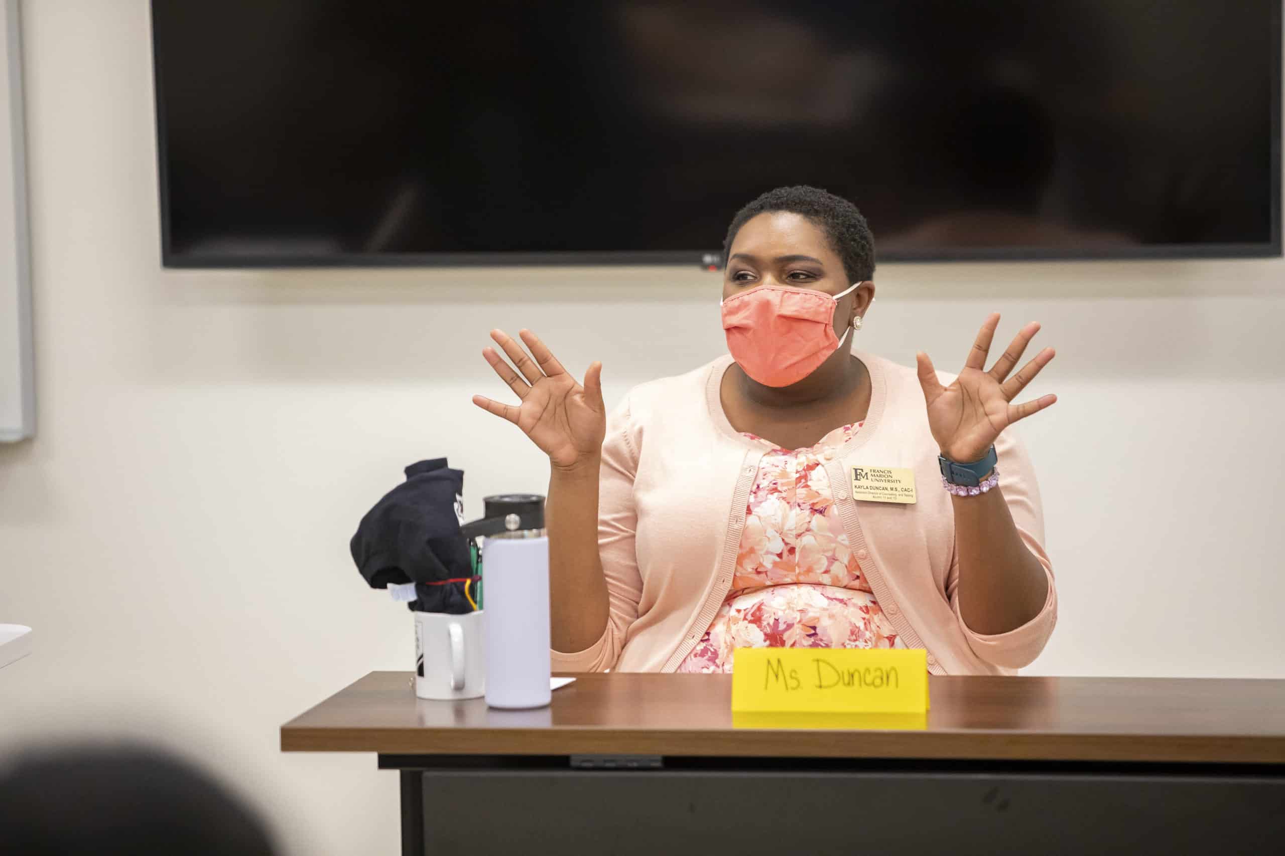 A panelist speaks to a class.