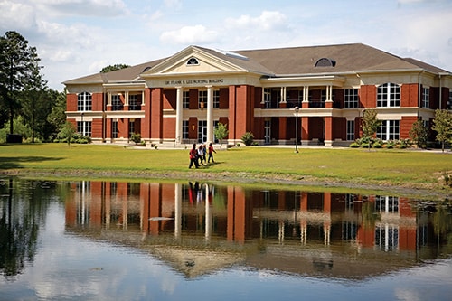 LNB-with-students-500 Front view of Lee Nursing Building and pond