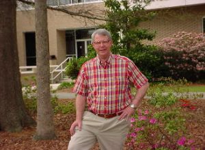 Math professor standing in front of McNair Science Building