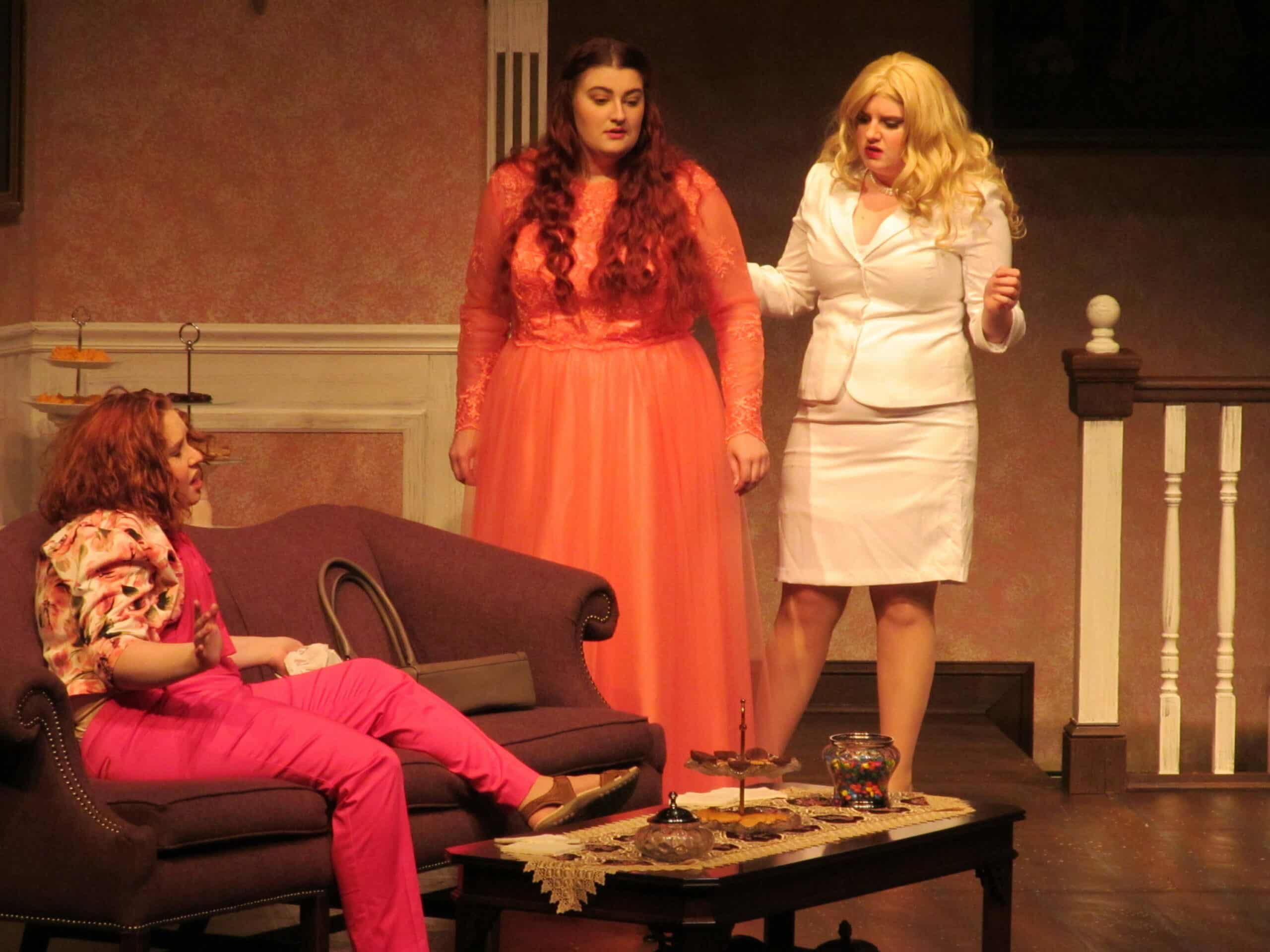 Three women on stage performing Bridesmaids
