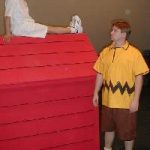 Student standing, student on dog house during Charlie Brown performance