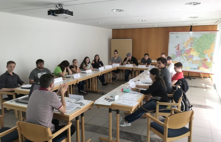 Students listening to the professor in a group circle