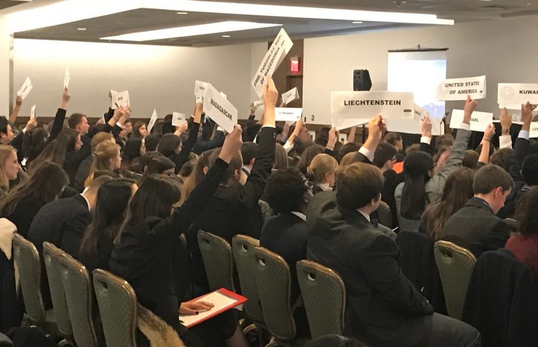 Students raising their country's sign