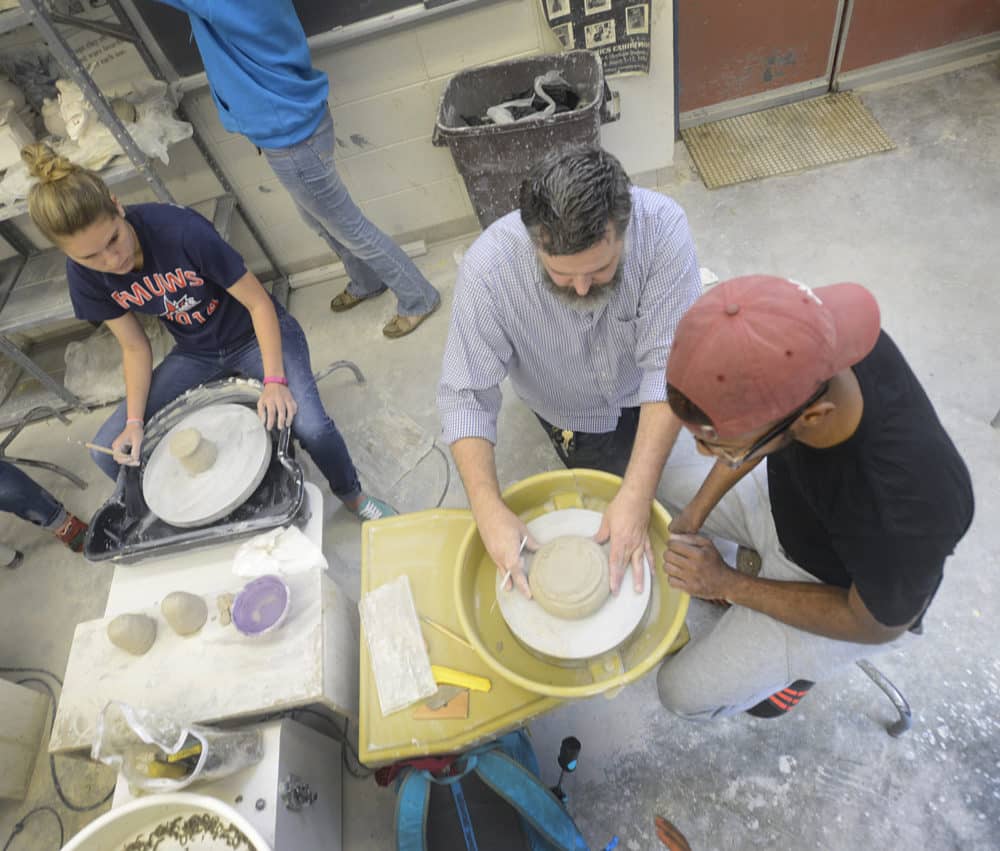 Sculpting FMU students and professors sculpting in class