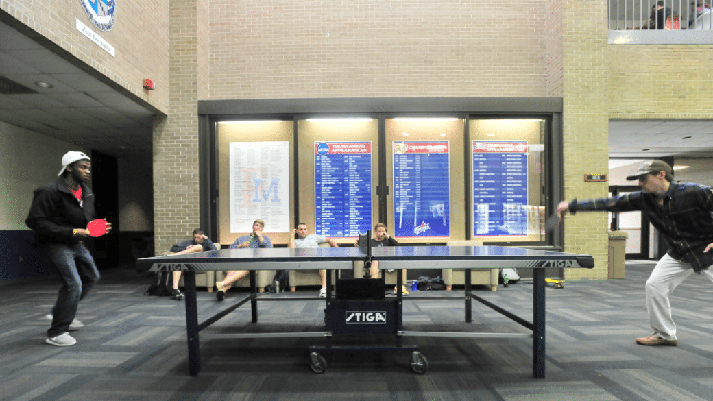 Two students playing ping pong in the University Center