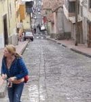 Cropped photo of woman walking up a street