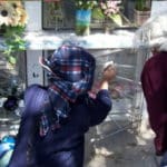 People placing things on a memory wall