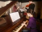 A student plays piano in the FMU Recording Studio