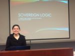 Photo of woman standing infront of Sovereign Logic Powerpoint