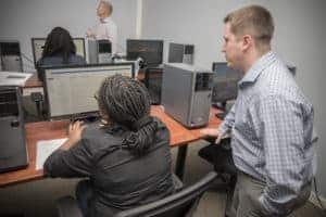 Two people looking at a computer