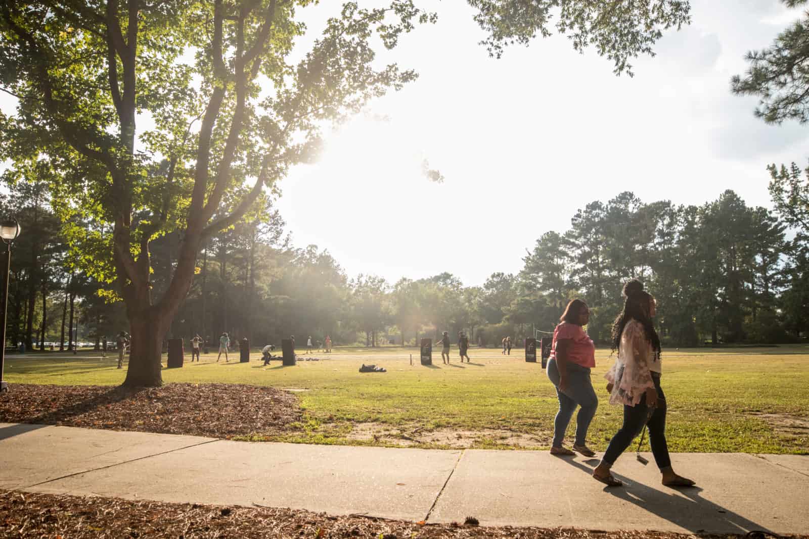 Students walk past a game of archery tag.