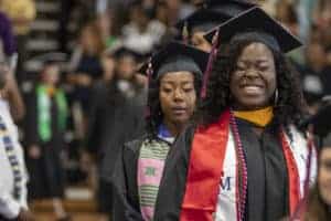 Graduates walking into commencement