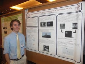 Rouse standing in front of his research poster