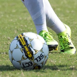 close up of soccer ball and player's feet kicking ball