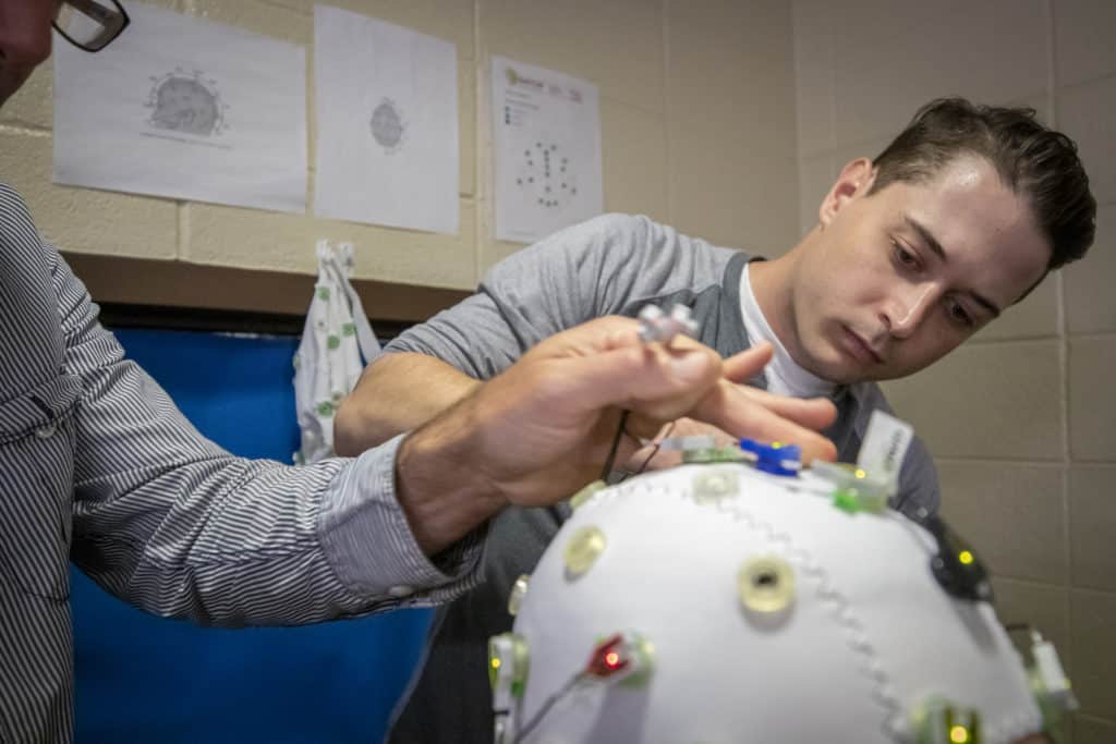 Dr. Sargent and a graduate student hook up an EEG.