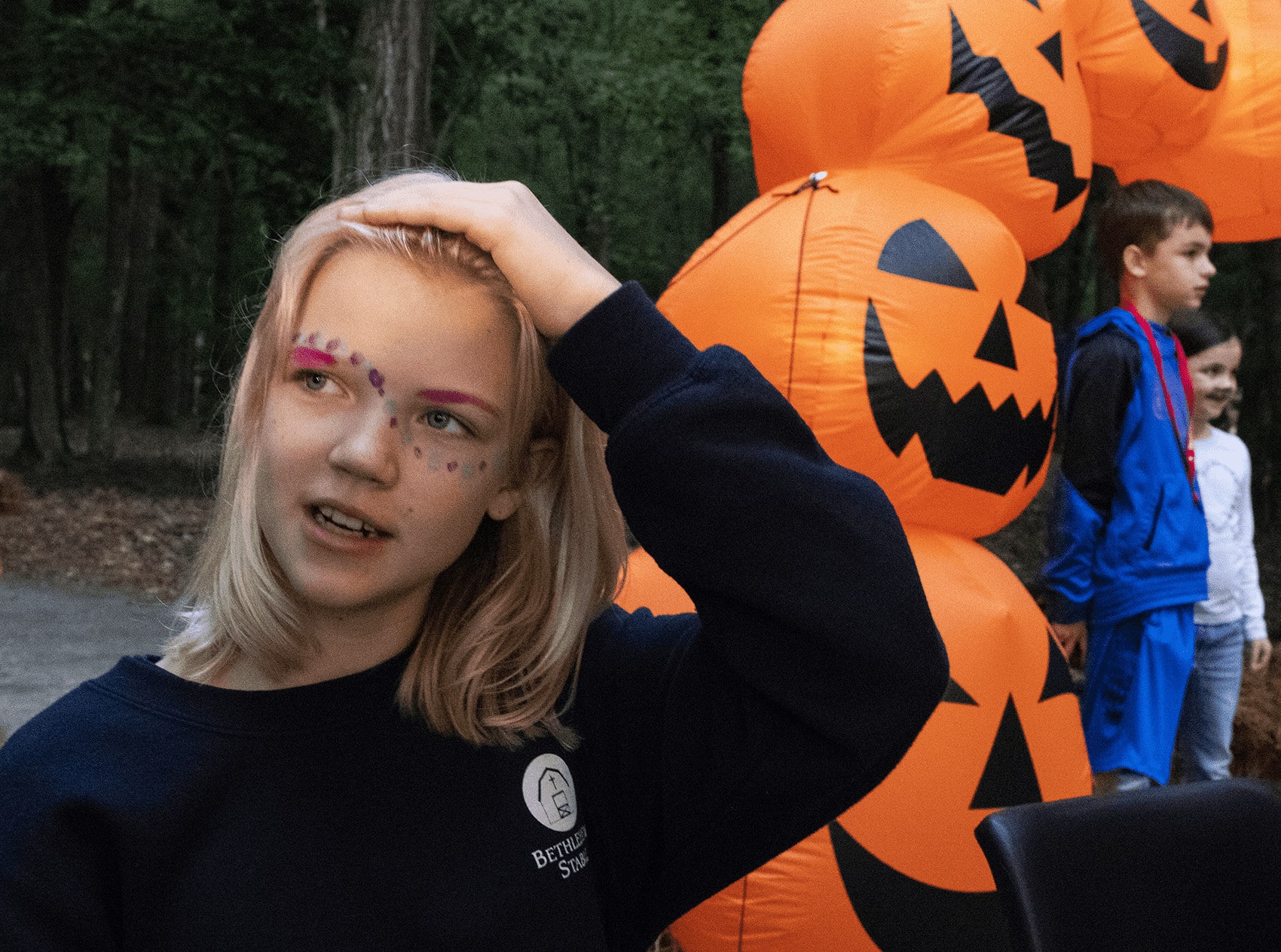 A young girl wears face paint.