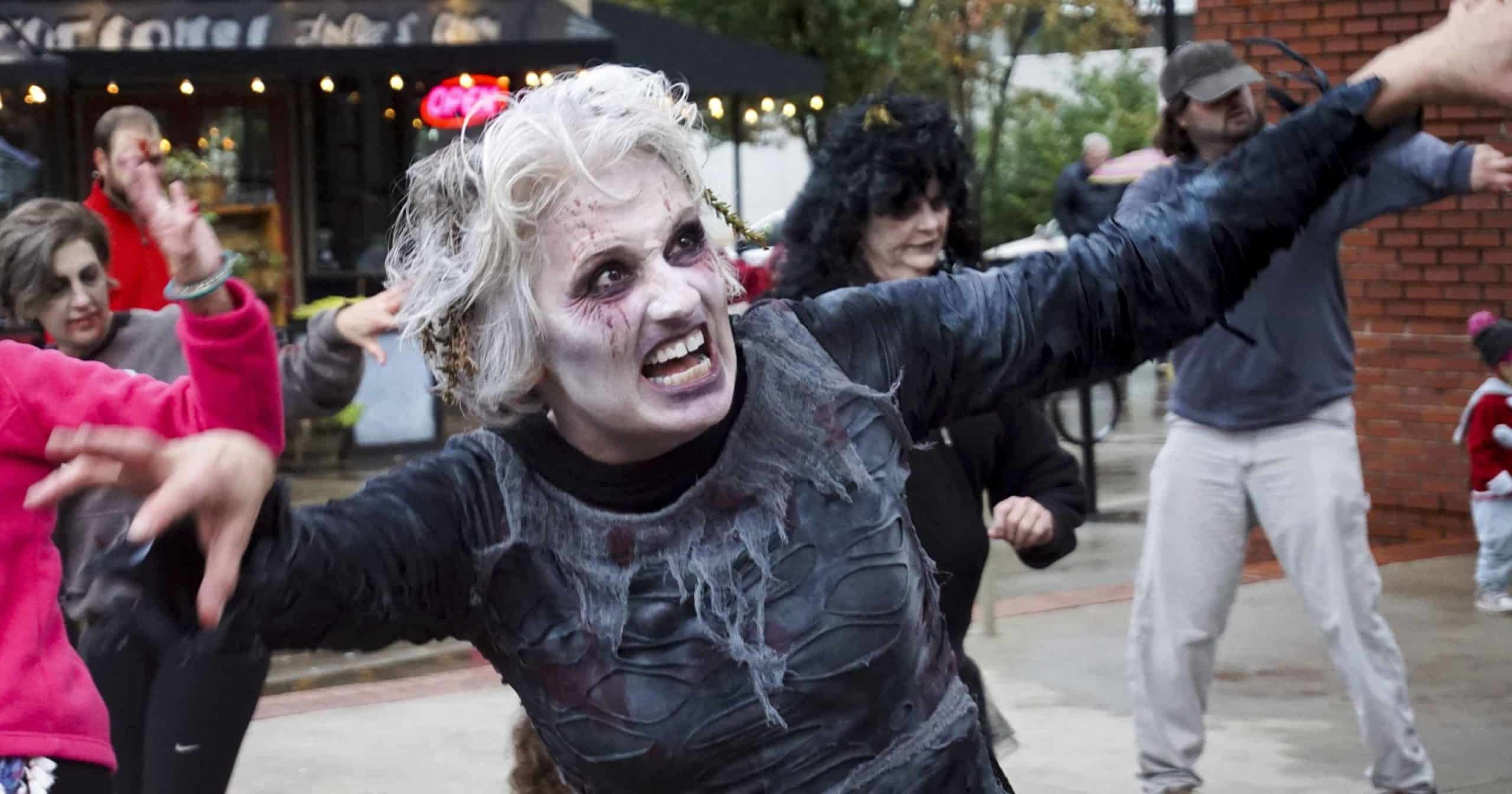 A woman dresses like a zombie.