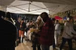 People gather under a tent during Doug's Day.