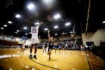 An FMU Patriot makes a shot during a basketball game.