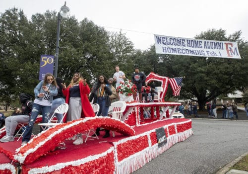 Students jam out on a float during homecoming.