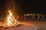 Students gather around the homecoming bonfire.