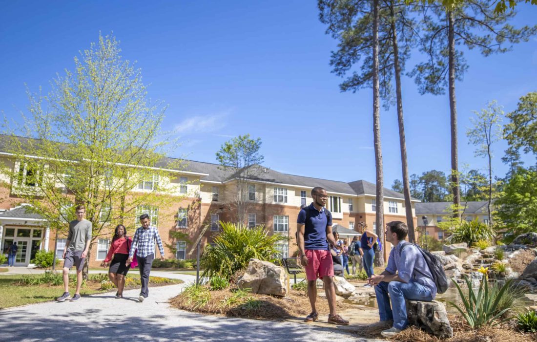 Students mingle outside of the apartments.