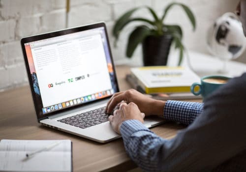 A man works on a laptop.