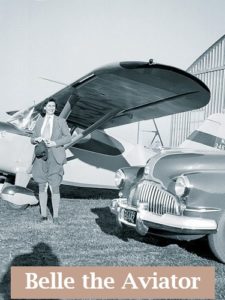 Belle in front of an airplane