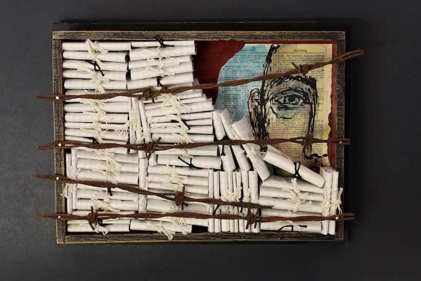 A mixed media piece depicting a box of scrolls.