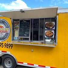 yellow food truck serving bbq