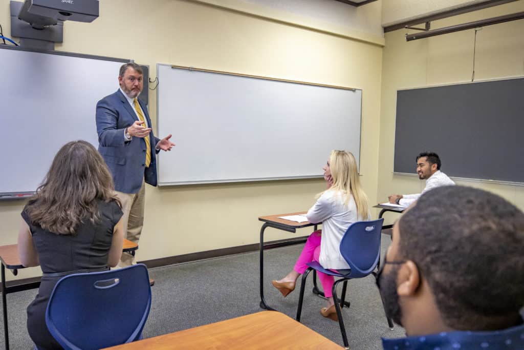 FMU-04232021-MBA-Commercial-17 A business professor speaks to a class.