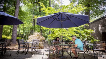 Students dining at the POD Cafe's outdoor patio