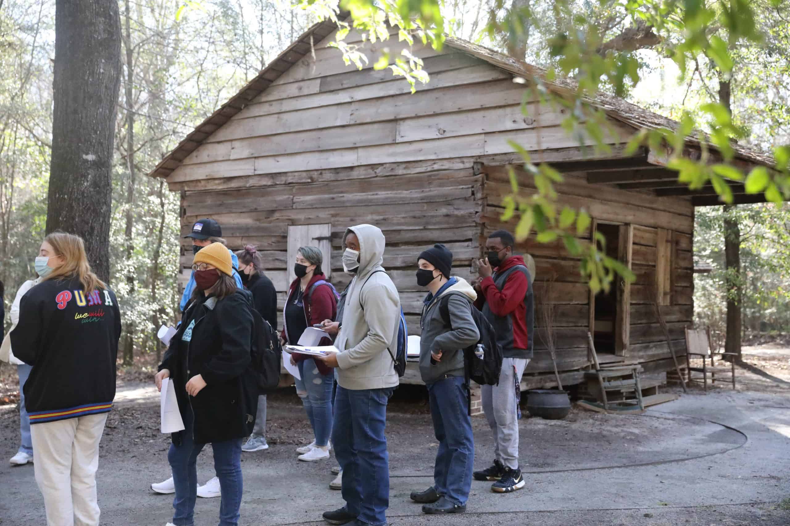 Students investigate the Hewn TImber Cabins.
