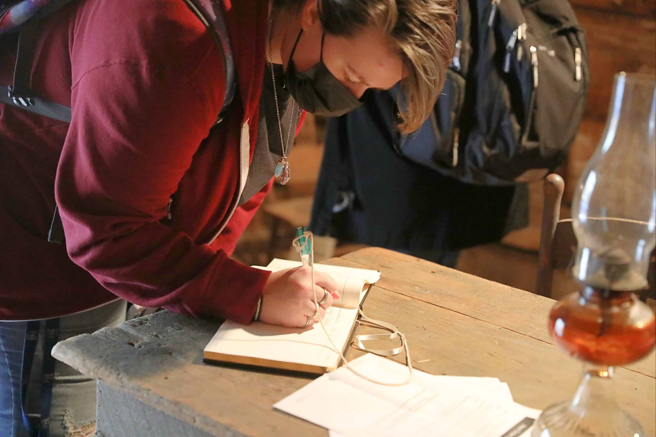 Students investigate the Hewn TImber Cabins.