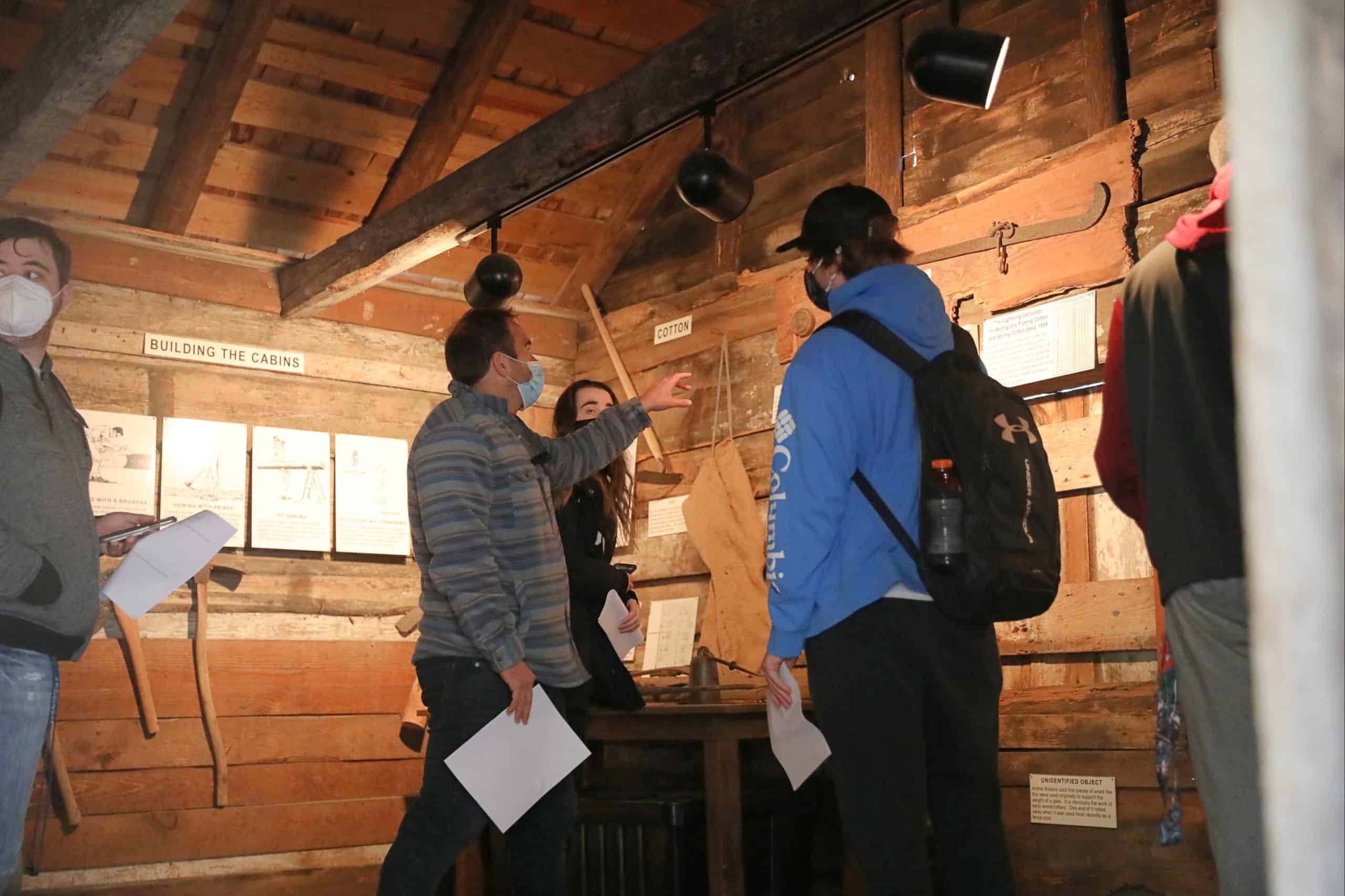 Students investigate the Hewn TImber Cabins.