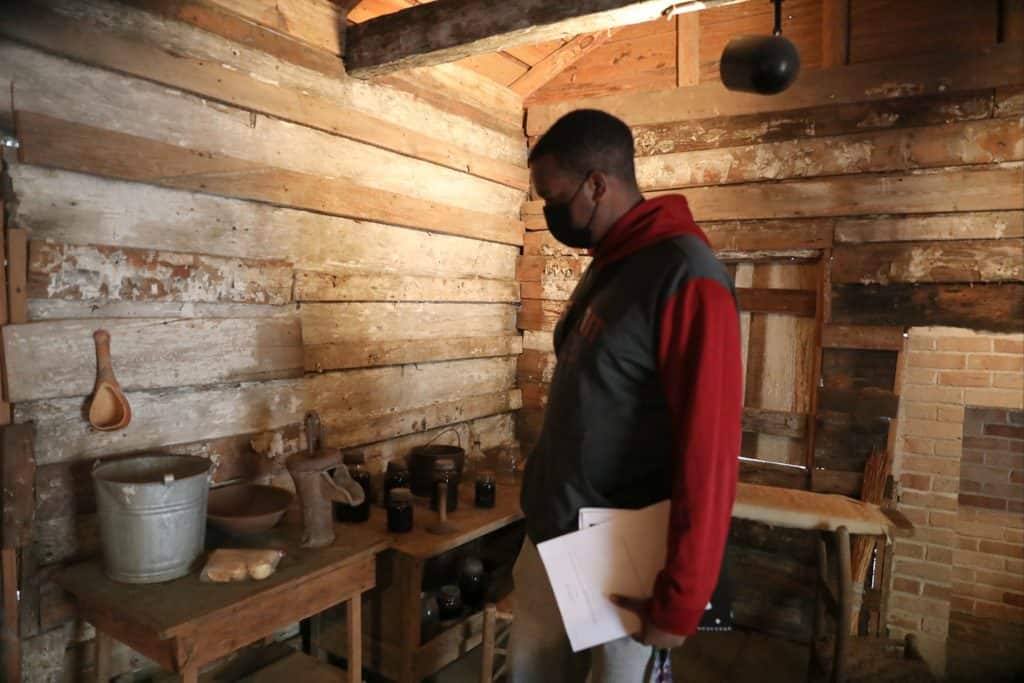 Students investigate the Hewn TImber Cabins.