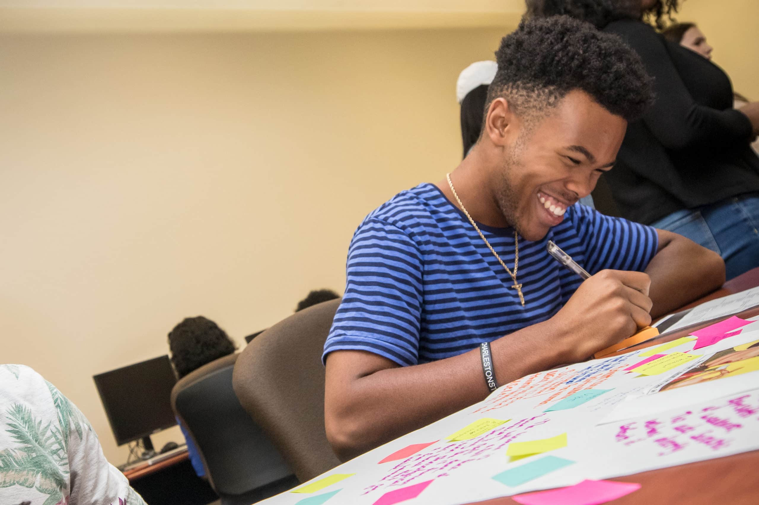 man drawing and smiling