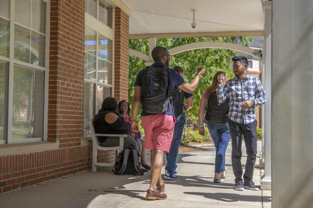 men walking by each other