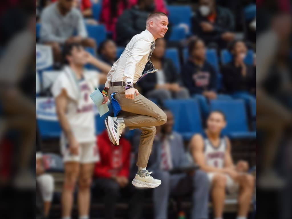 man jumping at basketball game